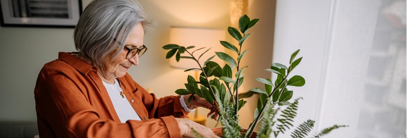 Older lady tending to her plant