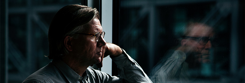 Thoughtful man looking out of the window