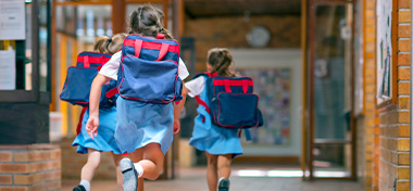 private school children running into school