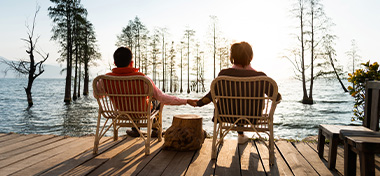 Couple relaxing, looking over the lake together