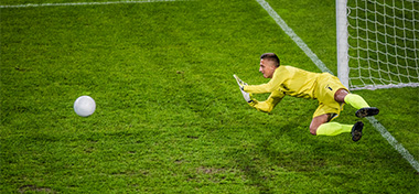 Goalie in mid-air defending goal