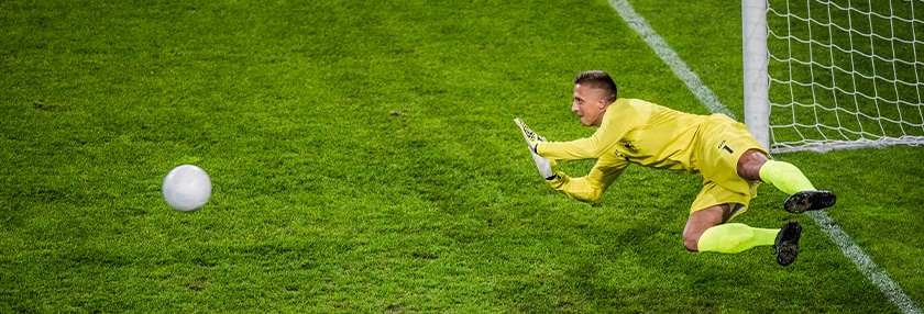 Goalie in mid-air defending goal