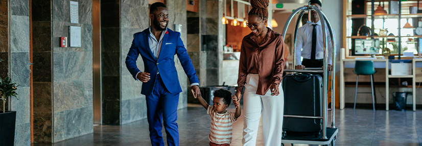 Family going to hotel room with luggage