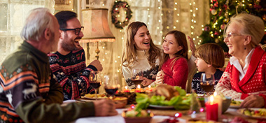 Extended family talking during Christmas dinner at home
