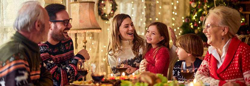 Extended family talking during Christmas dinner at home
