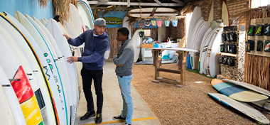 Small business owner doing sales in his surf shop