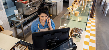 SME owner working in her shop on the phone 