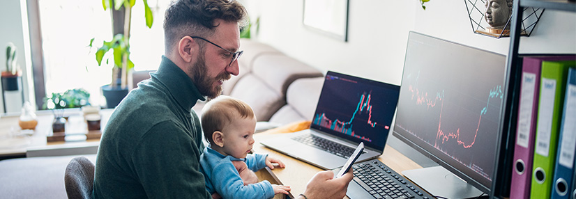 Man looking at trading app on his smart phone from his home office