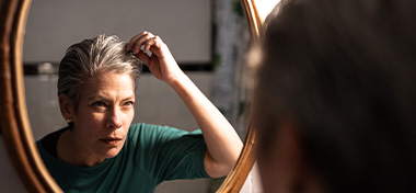 Mature woman looking in the mirror