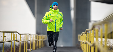 Male running over the bridge