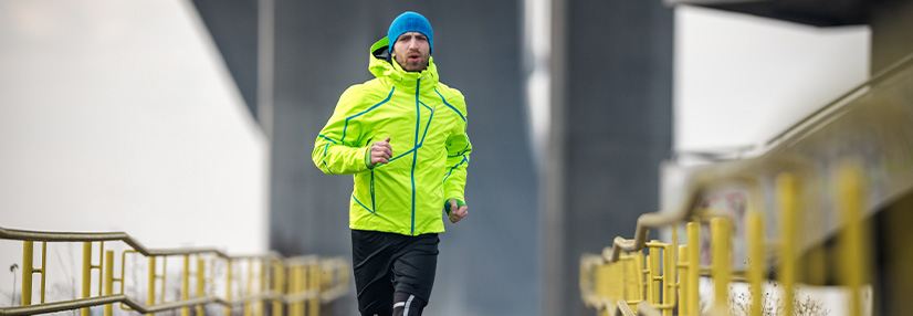 Male running over the bridge
