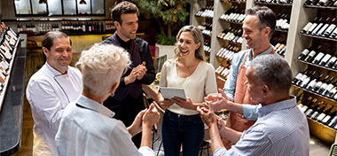 Business owner having a pep talk with her team at a restaurant 