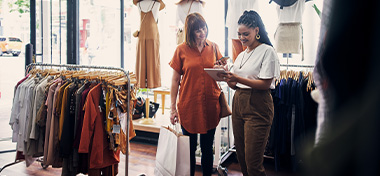 Business owner talking to a customer in her clothes shop