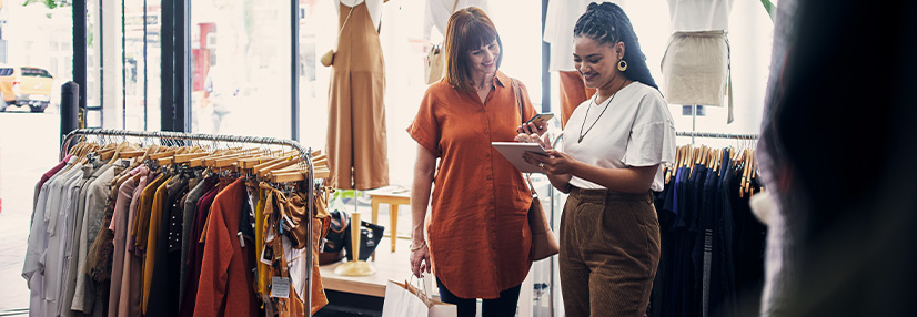Business owner talking to a customer in her clothes shop