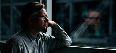 Thoughtful man looking out of the window
