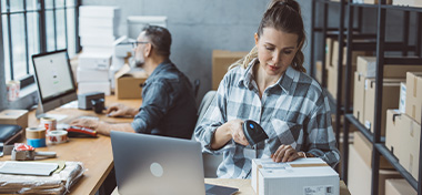 Two business partners working together at warehouse for online seller business