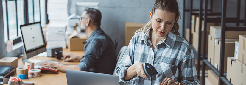 Two business partners working together at warehouse for online seller business