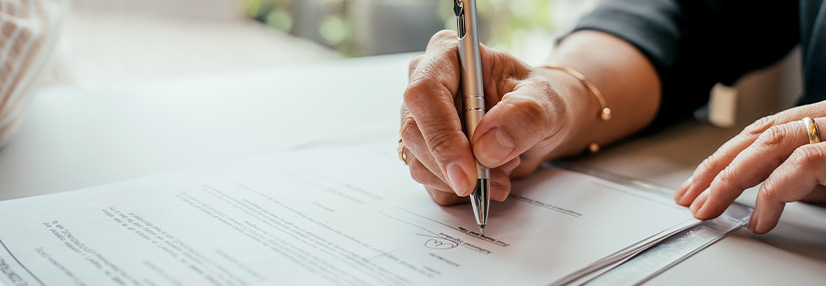 Someone signing documents