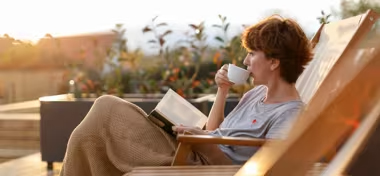 Lady relaxing in a chair reading her book