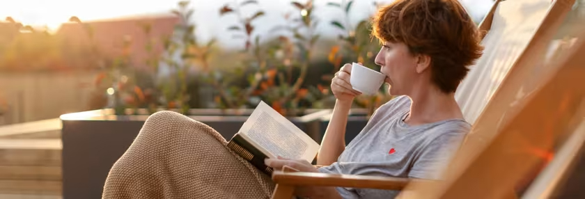 Lady relaxing in a chair reading her book