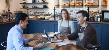 business owners with financial adviser