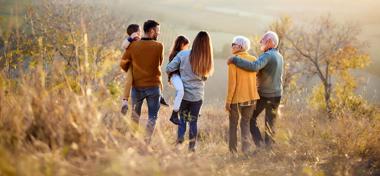 Back view of multi-generation family moving down the hill.