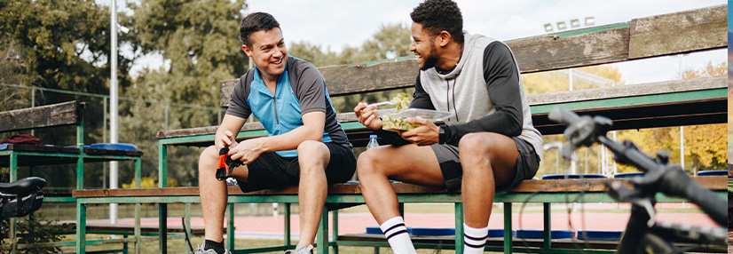Two males chatting on a bench