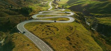 View of serpentine road in Swiss Alps in autumn