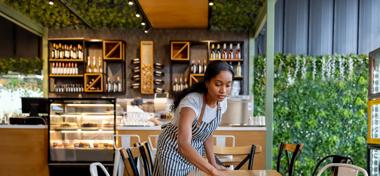 Waitress cleaning tables