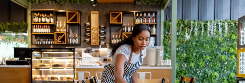 Waitress cleaning tables