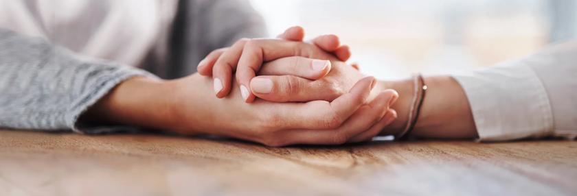 Two people holding hands