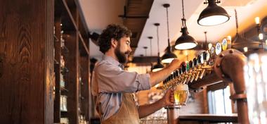 Bar tender pulling drinks