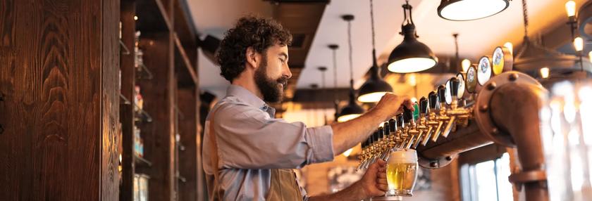 Bar tender pulling drinks