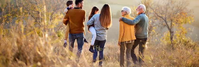 Back view of multi-generation family moving down the hill.