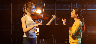 A music teacher guides her student
