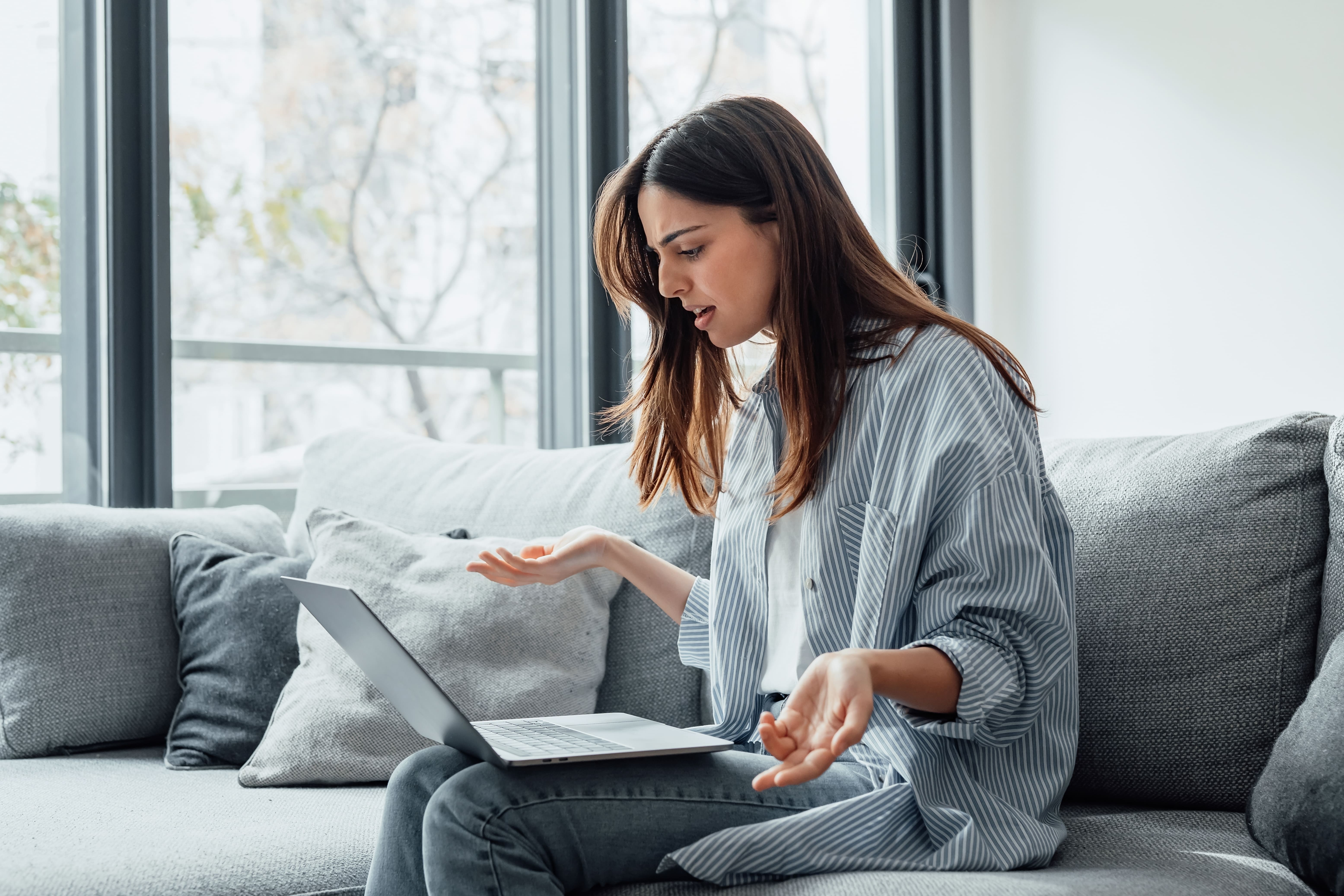 Woman confused at laptop