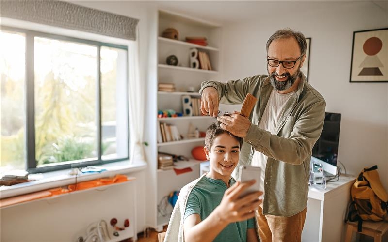 father cutting sons hair