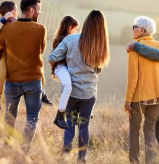 Back view of multi-generation family moving down the hill.